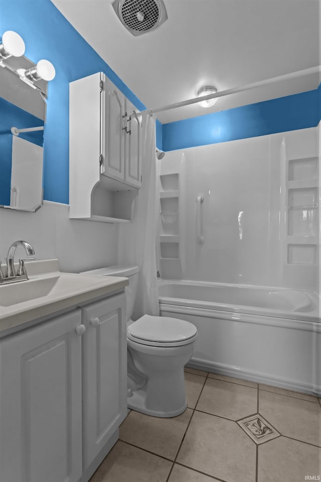 bathroom with tile patterned floors, shower / bathtub combination with curtain, toilet, and vanity