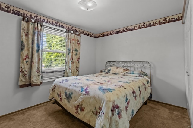 carpeted bedroom featuring baseboards
