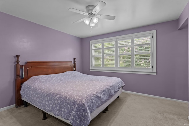 carpeted bedroom featuring baseboards and ceiling fan