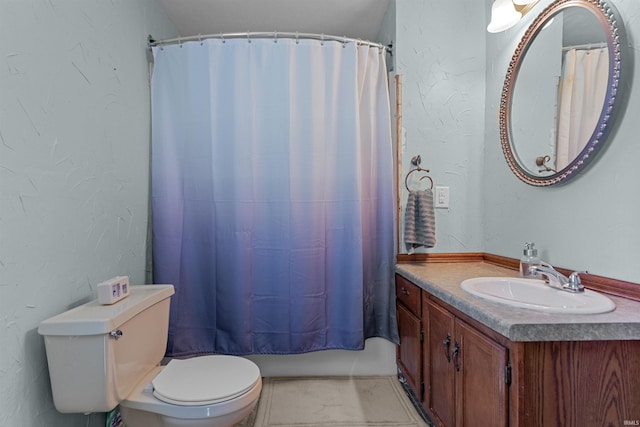 full bath with toilet, vanity, shower / bath combination with curtain, and a textured wall