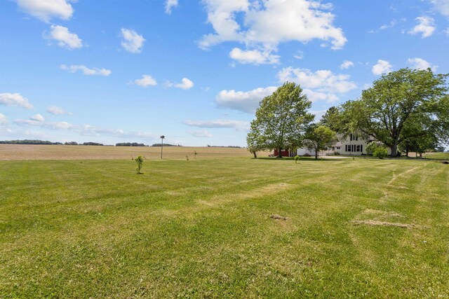 view of green lawn with a view of countryside