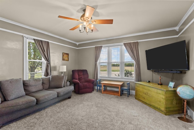 carpeted living area with ornamental molding and a ceiling fan