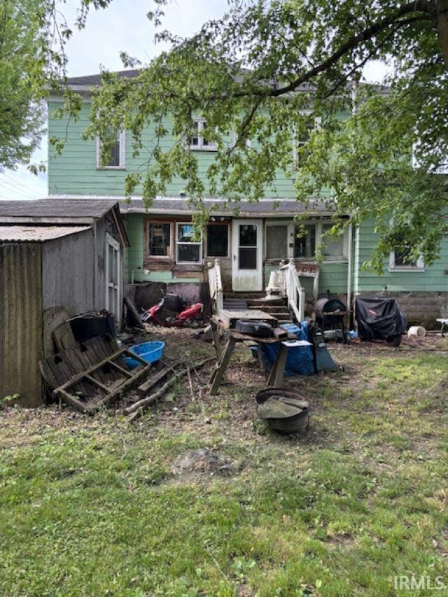 109 E Water St, Montpelier, IN 47359 - rear view of property featuring a shed and an outbuilding
