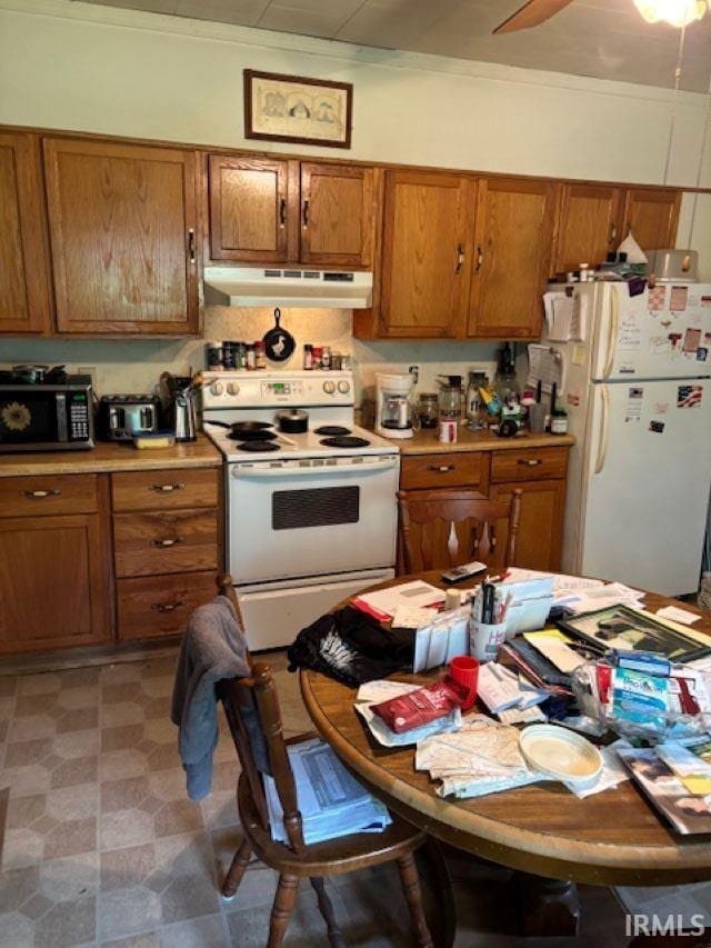 109 E Water St, Montpelier, IN 47359 - kitchen with white appliances, under cabinet range hood, and brown cabinetry