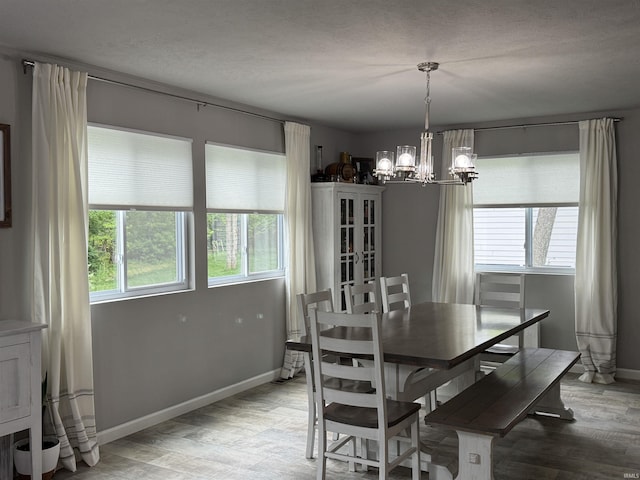 716 Gentry Ln, New Carlisle, IN 46552 - dining area featuring a chandelier, light wood-style flooring, and baseboards