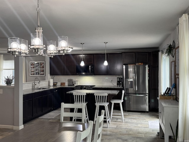 716 Gentry Ln, New Carlisle, IN 46552 - kitchen featuring stainless steel refrigerator with ice dispenser, black microwave, backsplash, a sink, and light stone counters