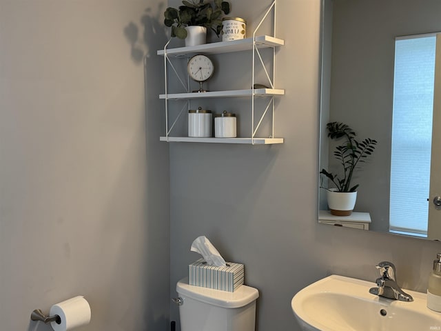 716 Gentry Ln, New Carlisle, IN 46552 - half bathroom featuring a sink and toilet