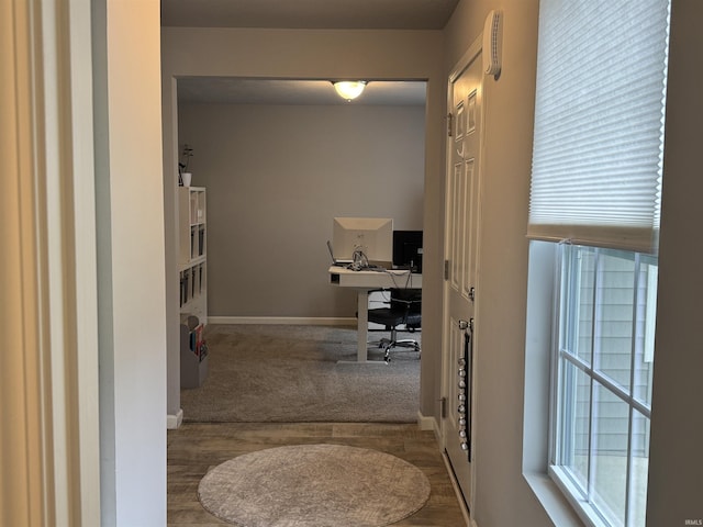 716 Gentry Ln, New Carlisle, IN 46552 - corridor with a desk, baseboards, wood finished floors, and carpet