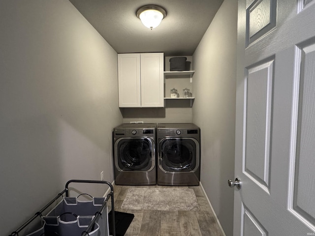 716 Gentry Ln, New Carlisle, IN 46552 - laundry area with washer and dryer, cabinet space, wood finished floors, and baseboards