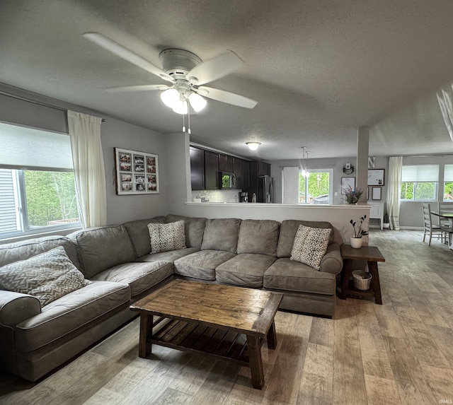 716 Gentry Ln, New Carlisle, IN 46552 - living room with light wood-style floors, a ceiling fan, and a textured ceiling
