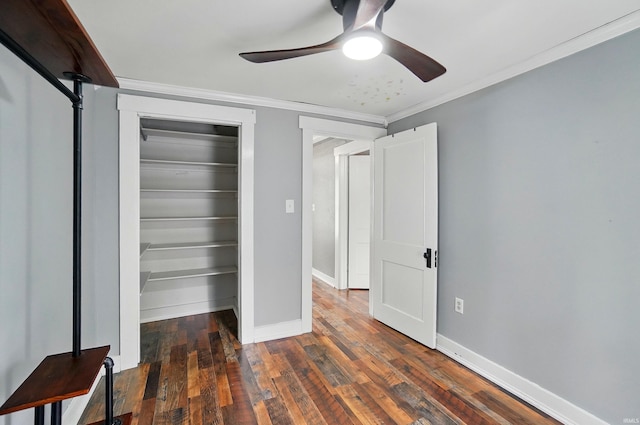 unfurnished bedroom featuring crown molding, wood-type flooring, baseboards, a closet, and ceiling fan
