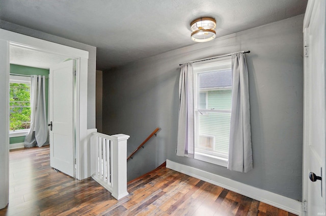 stairway featuring wood finished floors and baseboards
