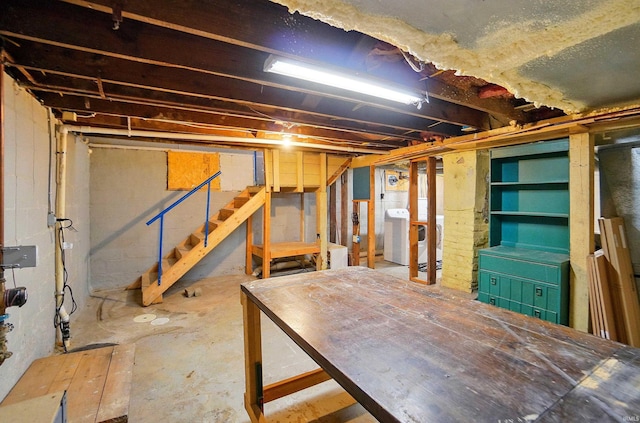 unfinished below grade area with stairs and washer / clothes dryer