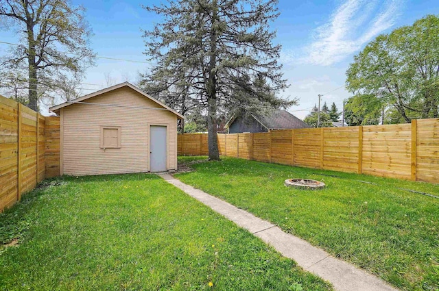 view of yard with an outdoor fire pit and an outdoor structure