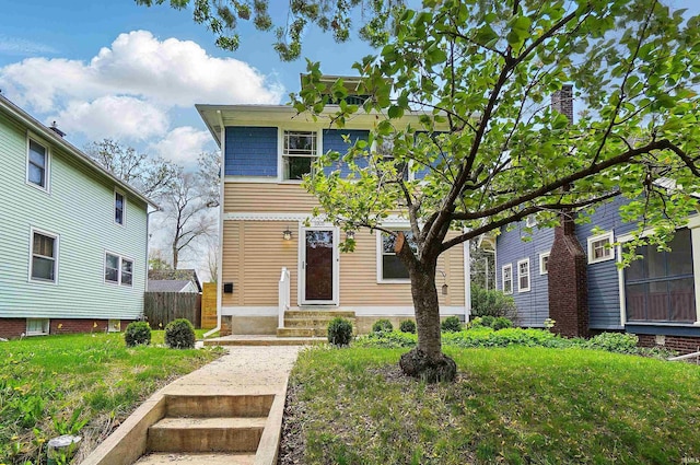 american foursquare style home featuring entry steps