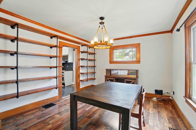 dining area featuring a chandelier, crown molding, dark wood-style floors, and baseboards