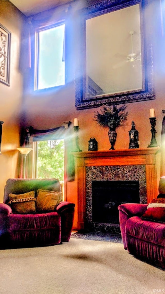 7751 E Fibia Pl, Fort Wayne, IN 46818 - carpeted living area featuring a fireplace and a ceiling fan