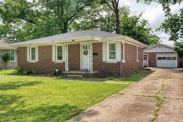 1616 N Roosevelt Dr, Evansville, IN 47711 - view of front of property featuring brick siding, an outbuilding, concrete driveway, and a front lawn