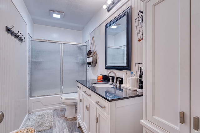 1616 N Roosevelt Dr, Evansville, IN 47711 - full bathroom with toilet, vanity, wood finished floors, and combined bath / shower with glass door