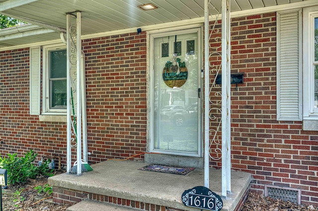 1616 N Roosevelt Dr, Evansville, IN 47711 - doorway to property with brick siding, a porch, and crawl space