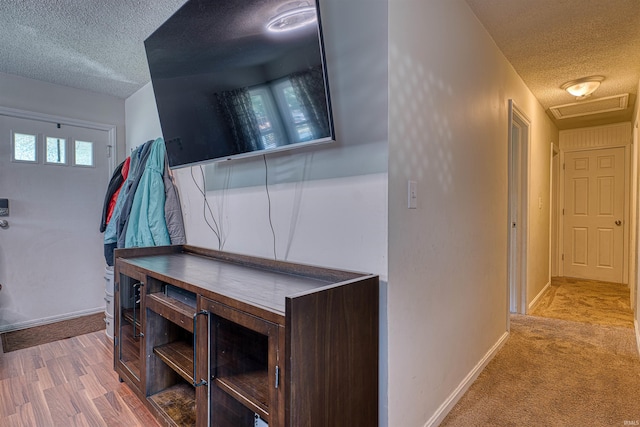 1616 N Roosevelt Dr, Evansville, IN 47711 - hall featuring a textured ceiling, baseboards, attic access, and carpet
