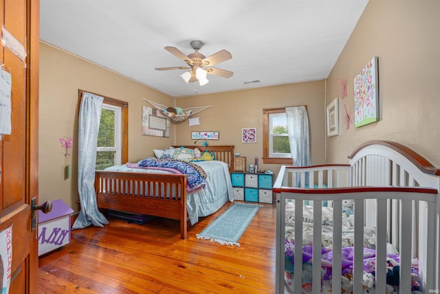 1239 County Road 28th Rd, Corunna, IN 46730 - bedroom featuring multiple windows, hardwood / wood-style floors, and a ceiling fan