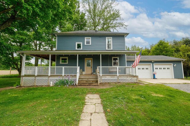 1239 County Road 28th Rd, Corunna, IN 46730 - farmhouse-style home featuring a porch, a front lawn, and a detached garage