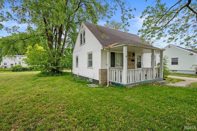 721 S Wellington St, South Bend, IN 46619 - view of front of property with a porch, a front lawn, and roof with shingles