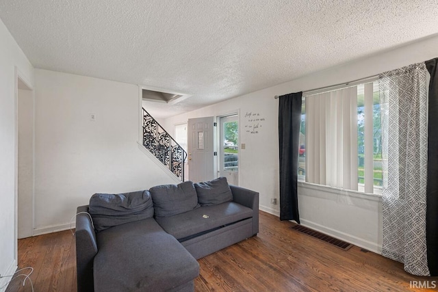 721 S Wellington St, South Bend, IN 46619 - living area featuring a textured ceiling, wood finished floors, stairway, and baseboards