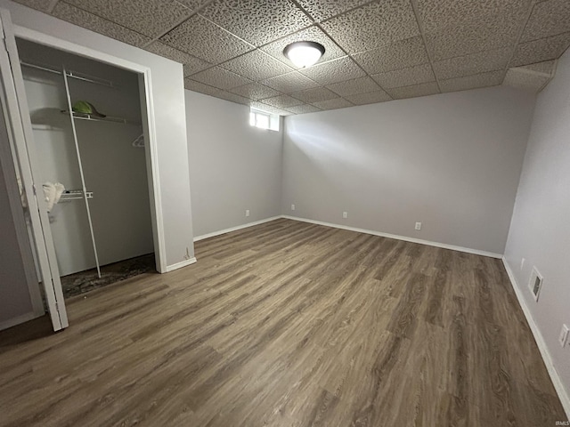 312 W Columbia St, Oakland City, IN 47660 - unfurnished bedroom with wood finished floors, baseboards, a drop ceiling, and a closet