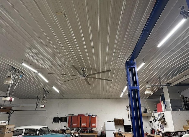 312 W Columbia St, Oakland City, IN 47660 - garage with a garage door opener, freestanding refrigerator, and a ceiling fan