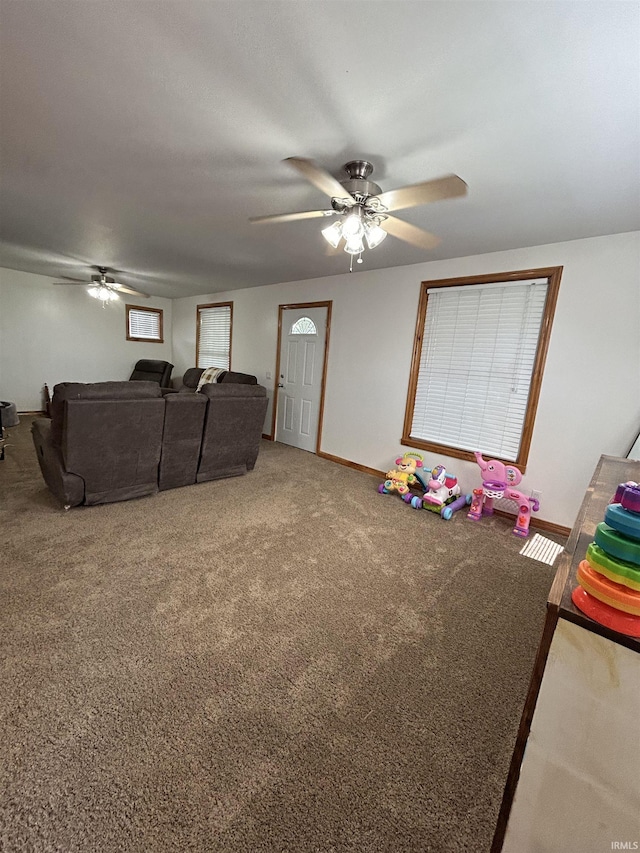 312 W Columbia St, Oakland City, IN 47660 - carpeted living room with ceiling fan and baseboards