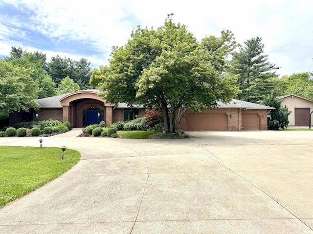 13392 N State Road 13, North Manchester, IN 46962 - view of front facade with brick siding, concrete driveway, a front lawn, and a garage