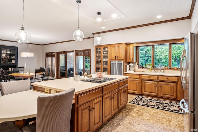 13392 N State Road 13, North Manchester, IN 46962 - kitchen with appliances with stainless steel finishes, light countertops, brown cabinets, ornamental molding, and a kitchen island