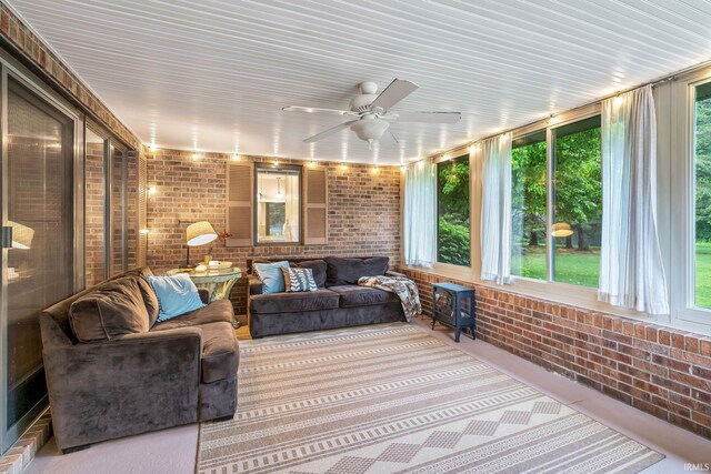 13392 N State Road 13, North Manchester, IN 46962 - sunroom / solarium with brick wall, a ceiling fan, an outdoor hangout area, and a wood stove