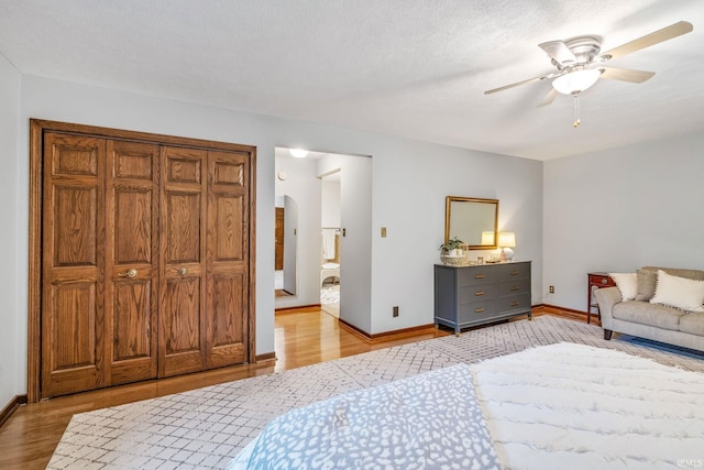 13392 N State Road 13, North Manchester, IN 46962 - bedroom with arched walkways, light wood-type flooring, baseboards, and ceiling fan