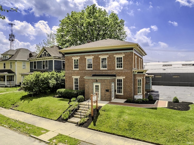 607 E Charles St, Muncie, IN 47305 - view of front of property featuring brick siding and a front lawn