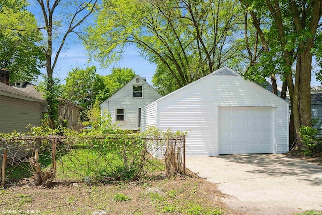1842 Obrien St, South Bend, IN 46628 - view of property exterior featuring concrete driveway, an outbuilding, a detached garage, and fence