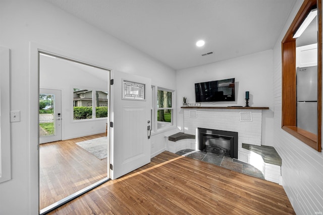 3 Ems T20 Ln, Leesburg, IN 46538 - unfurnished living room featuring wood finished floors, a fireplace, baseboards, and recessed lighting