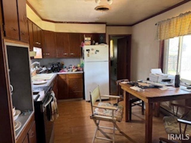 2402 Greytwig Dr, Kokomo, IN 46902 - kitchen with freestanding refrigerator, electric range, a sink, wood finished floors, and light countertops