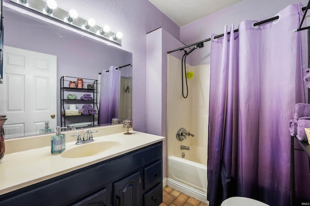 bathroom featuring vanity, shower / tub combo with curtain, and a textured wall