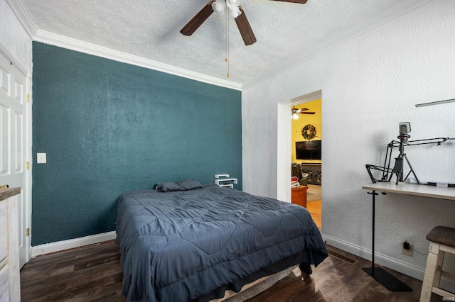 bedroom with crown molding, wood finished floors, a textured ceiling, a textured wall, and baseboards