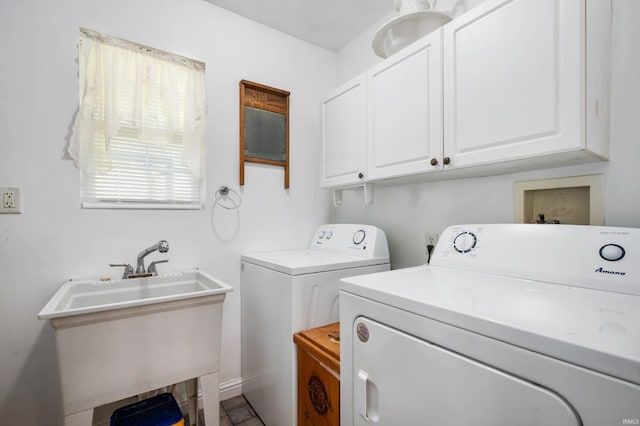 washroom featuring washer and dryer and cabinet space