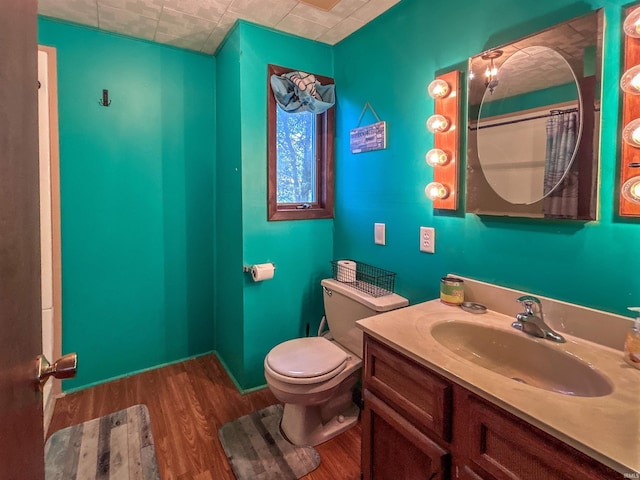 315 W Butcher St, Geneva, IN 46740 - full bathroom featuring wood finished floors, toilet, and vanity