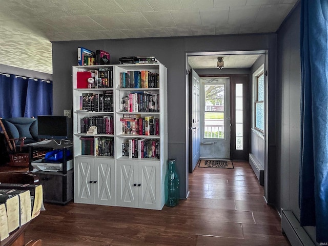 315 W Butcher St, Geneva, IN 46740 - entrance foyer with wood finished floors and a baseboard radiator