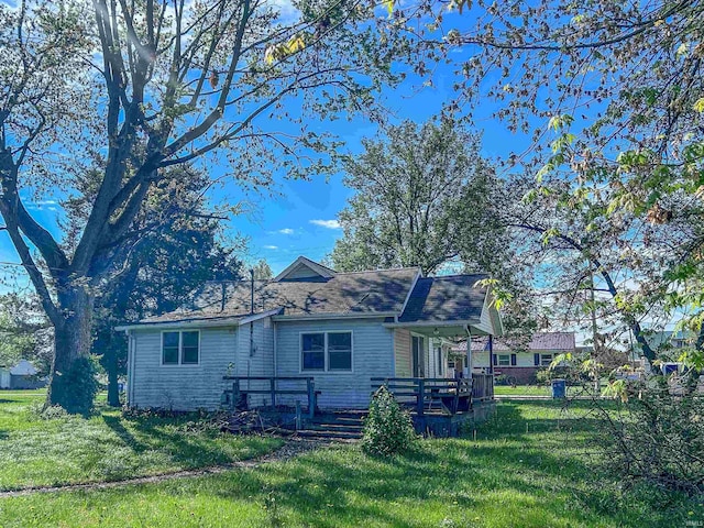 315 W Butcher St, Geneva, IN 46740 - view of front of house featuring a front yard and a wooden deck