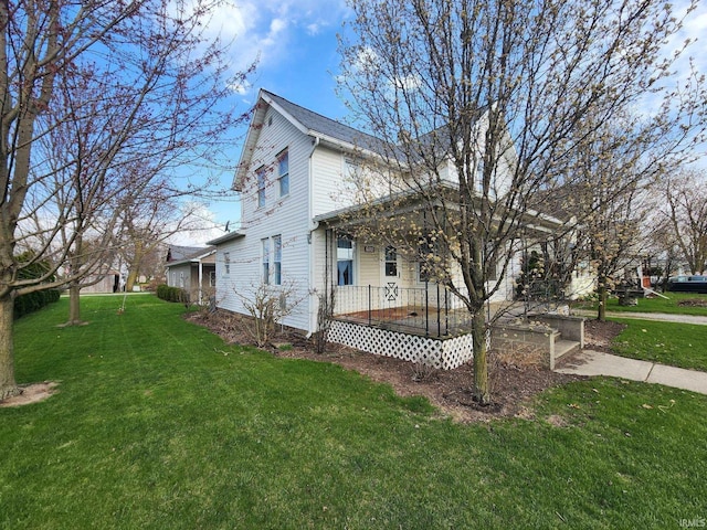 view of side of home featuring a lawn