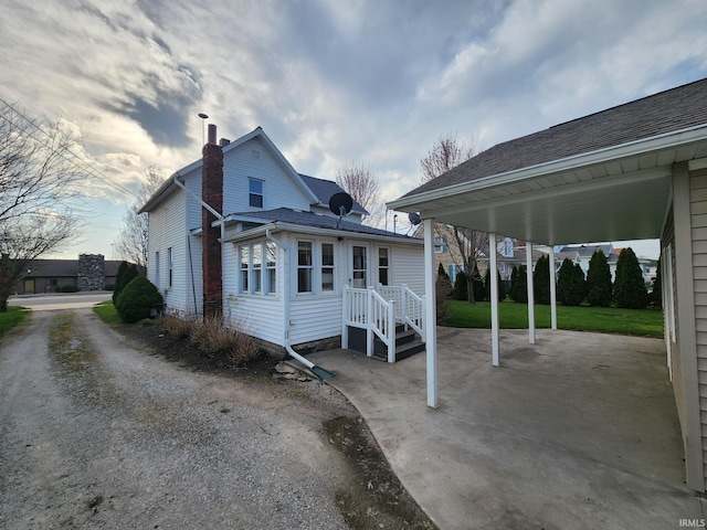 back of house featuring a chimney and a patio
