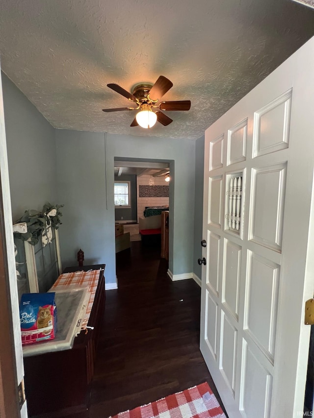 1206 King St, Lafayette, IN 47905 - hall featuring dark wood-style flooring, a textured ceiling, and baseboards