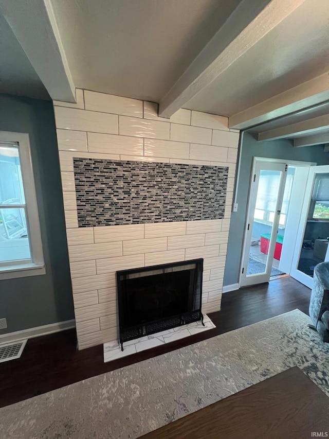 1206 King St, Lafayette, IN 47905 - detailed view of wood finished floors, a tiled fireplace, baseboards, and beamed ceiling
